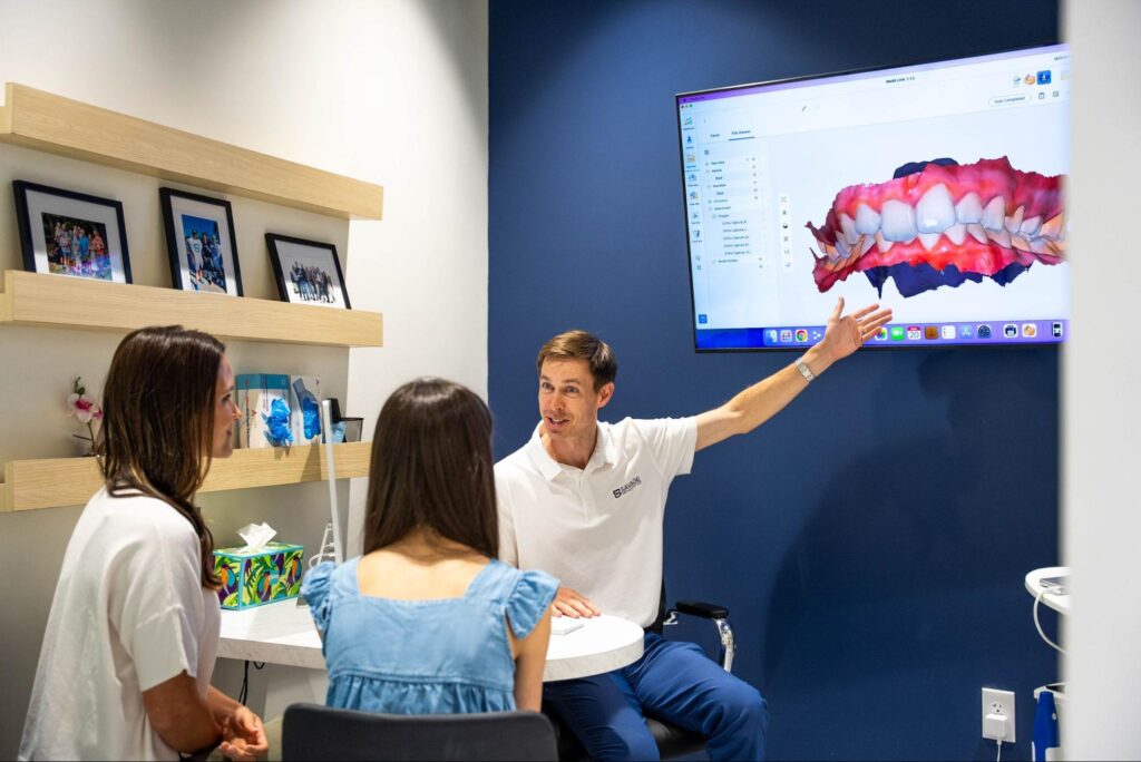 Dr. Savage talking to a patient about orthodontic treatment options.
